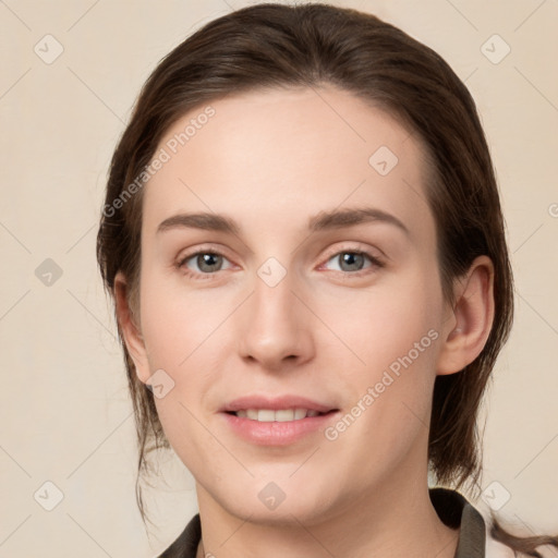 Joyful white young-adult female with medium  brown hair and grey eyes