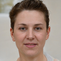 Joyful white adult female with short  brown hair and grey eyes