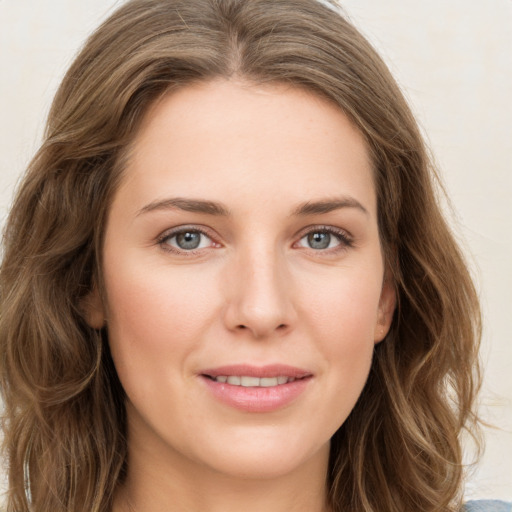 Joyful white young-adult female with long  brown hair and green eyes