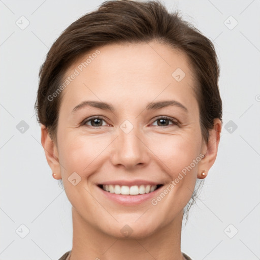 Joyful white young-adult female with short  brown hair and grey eyes