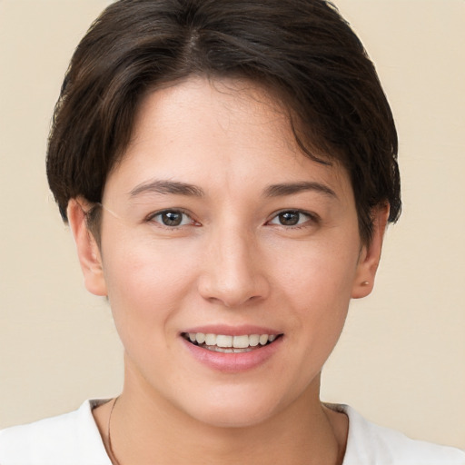 Joyful white young-adult female with short  brown hair and brown eyes