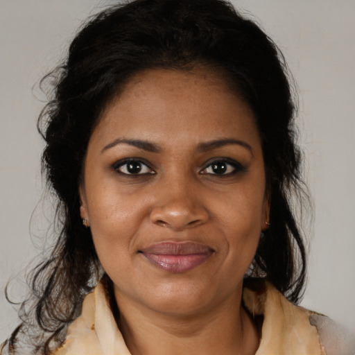 Joyful black adult female with medium  brown hair and brown eyes