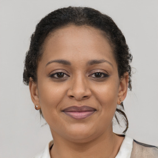 Joyful latino adult female with short  brown hair and brown eyes