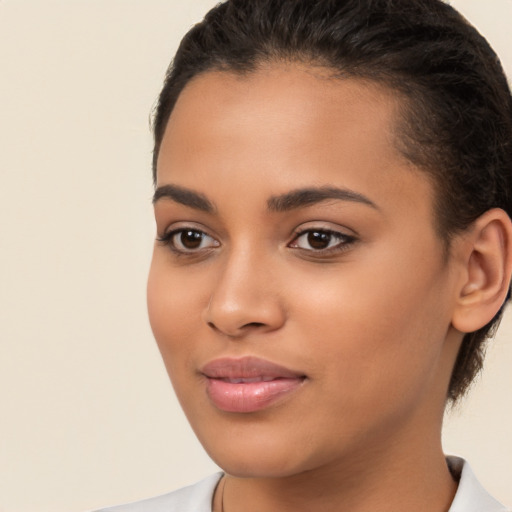 Joyful latino young-adult female with short  brown hair and brown eyes