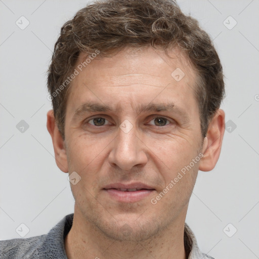 Joyful white adult male with short  brown hair and grey eyes