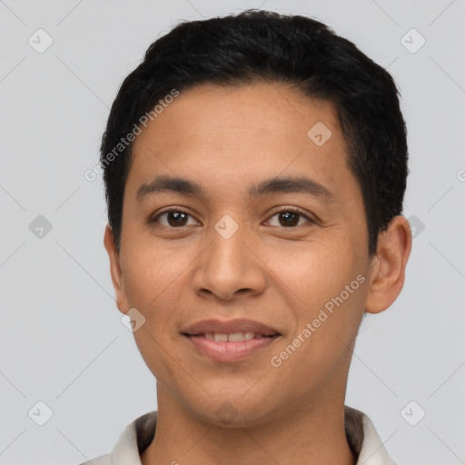 Joyful latino young-adult male with short  black hair and brown eyes