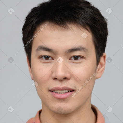 Joyful asian young-adult male with short  brown hair and brown eyes