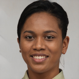 Joyful latino young-adult female with short  brown hair and brown eyes