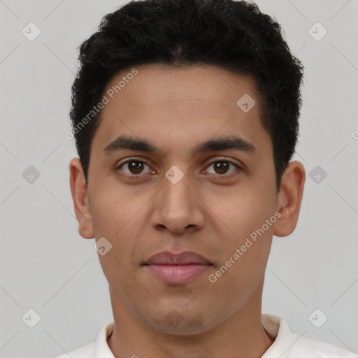 Joyful latino young-adult male with short  brown hair and brown eyes