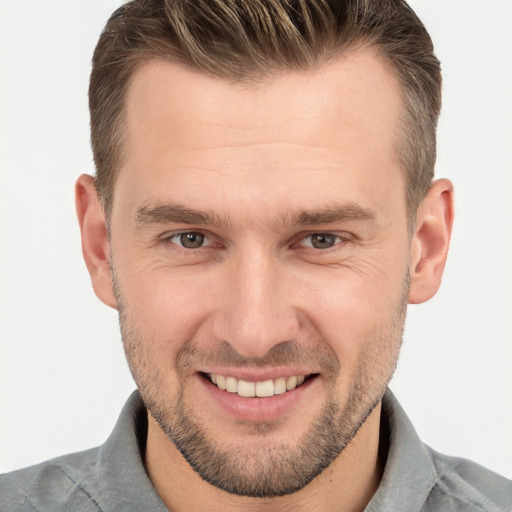 Joyful white young-adult male with short  brown hair and brown eyes