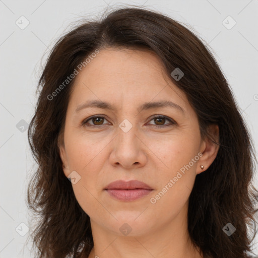 Joyful white adult female with long  brown hair and brown eyes