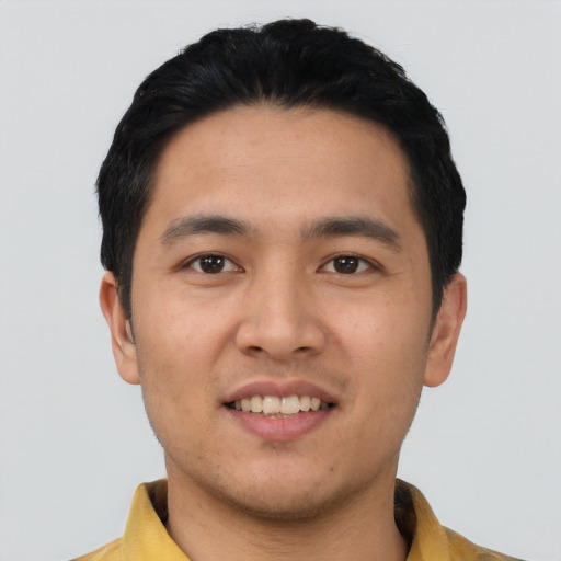 Joyful asian young-adult male with short  black hair and brown eyes