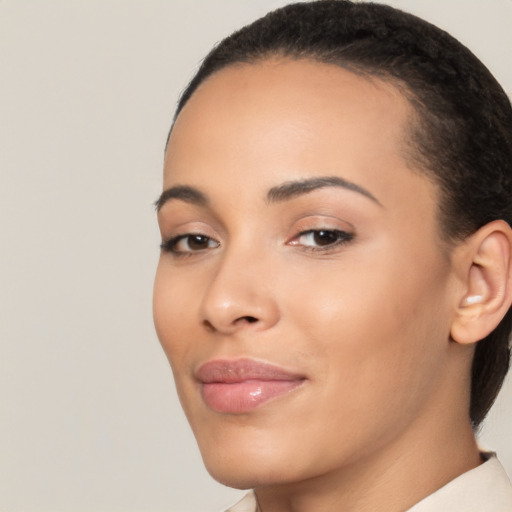 Joyful latino young-adult female with short  black hair and brown eyes