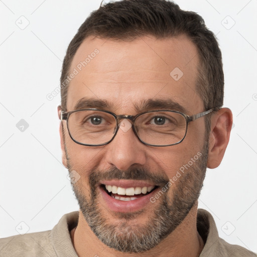 Joyful white adult male with short  brown hair and brown eyes