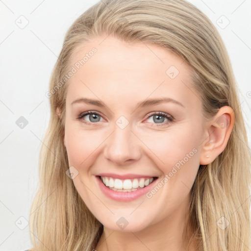 Joyful white young-adult female with long  brown hair and blue eyes