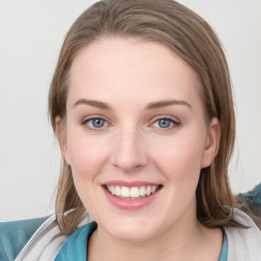 Joyful white young-adult female with medium  brown hair and blue eyes