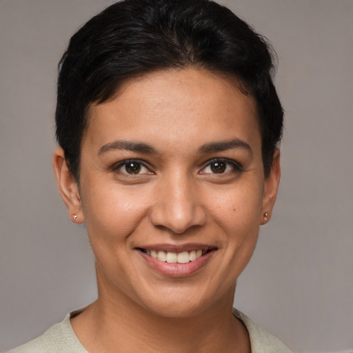 Joyful white young-adult female with short  brown hair and brown eyes