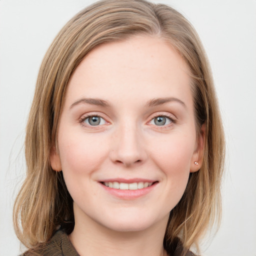 Joyful white young-adult female with long  brown hair and blue eyes