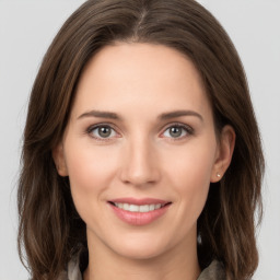 Joyful white young-adult female with long  brown hair and grey eyes