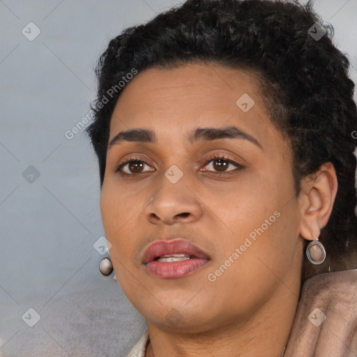 Joyful black young-adult female with short  black hair and brown eyes