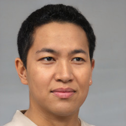 Joyful latino adult male with short  brown hair and brown eyes