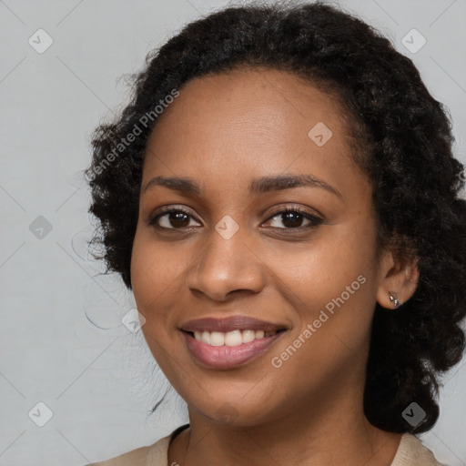 Joyful black young-adult female with long  black hair and brown eyes