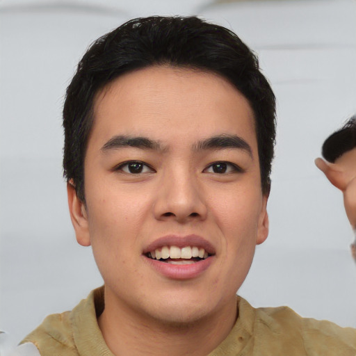 Joyful asian young-adult male with short  brown hair and brown eyes