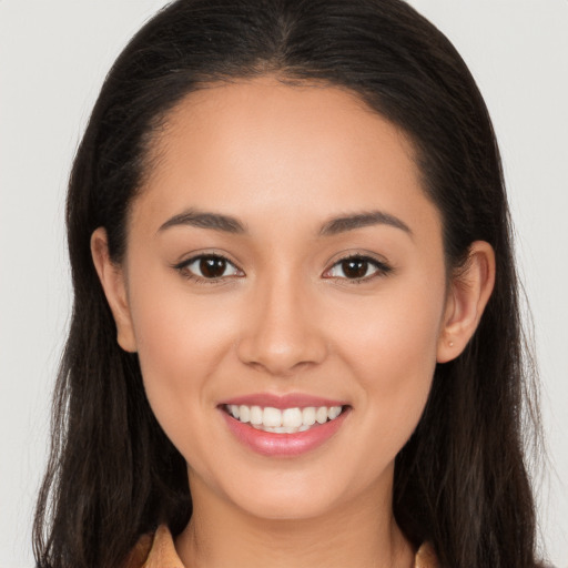 Joyful white young-adult female with long  brown hair and brown eyes