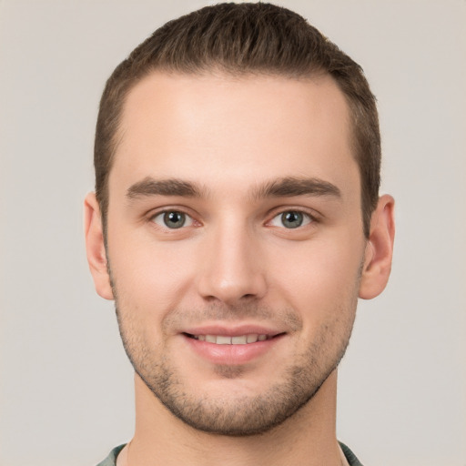 Joyful white young-adult male with short  brown hair and brown eyes