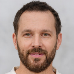 Joyful white adult male with short  brown hair and brown eyes