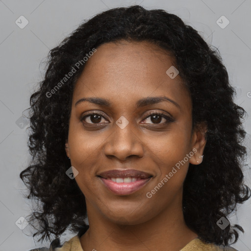 Joyful black young-adult female with long  black hair and brown eyes