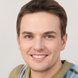 Joyful white young-adult male with short  brown hair and grey eyes