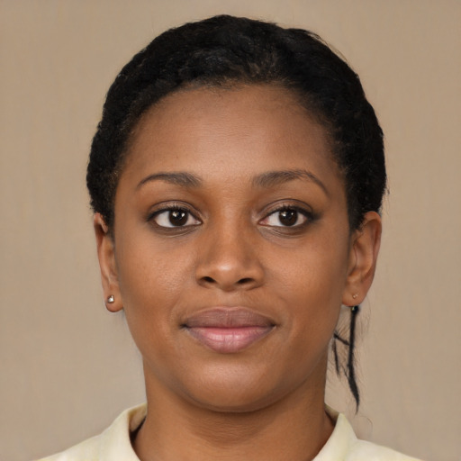 Joyful black young-adult female with short  black hair and brown eyes