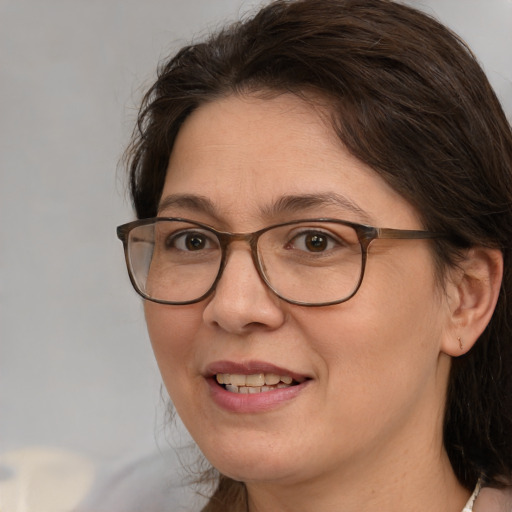 Joyful white adult female with medium  brown hair and brown eyes