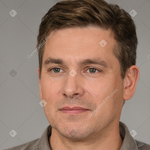 Joyful white adult male with short  brown hair and brown eyes