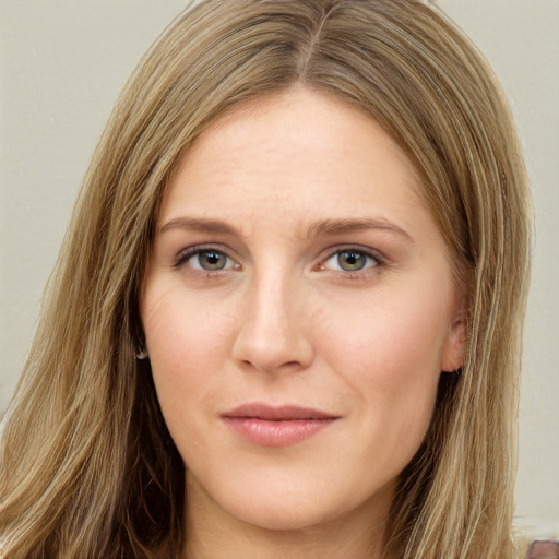 Joyful white young-adult female with long  brown hair and green eyes