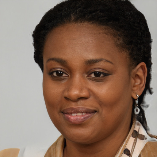Joyful black young-adult female with medium  brown hair and brown eyes