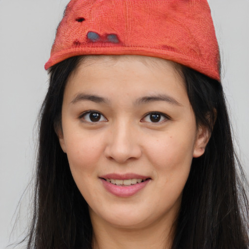 Joyful asian young-adult female with long  brown hair and brown eyes