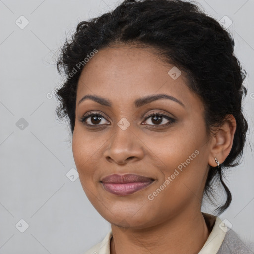 Joyful black young-adult female with medium  brown hair and brown eyes