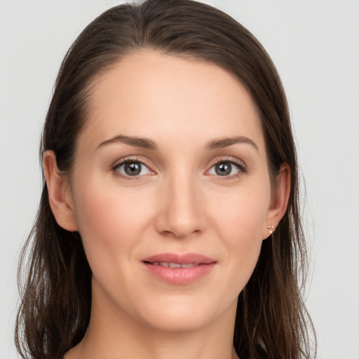 Joyful white young-adult female with long  brown hair and grey eyes