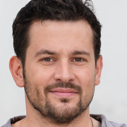 Joyful white adult male with short  brown hair and brown eyes