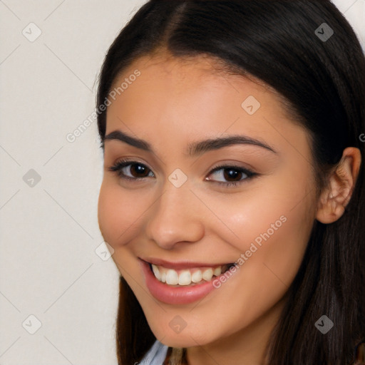 Joyful latino young-adult female with long  brown hair and brown eyes