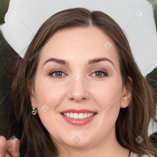 Joyful white young-adult female with long  brown hair and green eyes