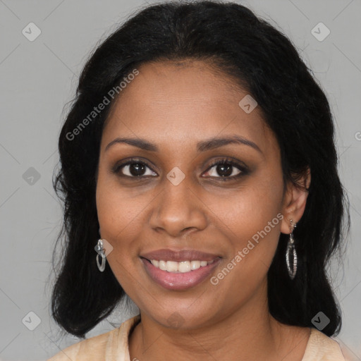 Joyful black young-adult female with long  black hair and brown eyes