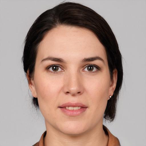 Joyful white young-adult female with medium  brown hair and brown eyes