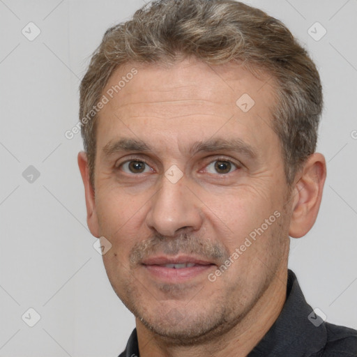 Joyful white adult male with short  brown hair and brown eyes