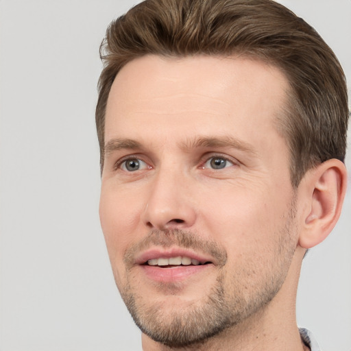 Joyful white adult male with short  brown hair and brown eyes