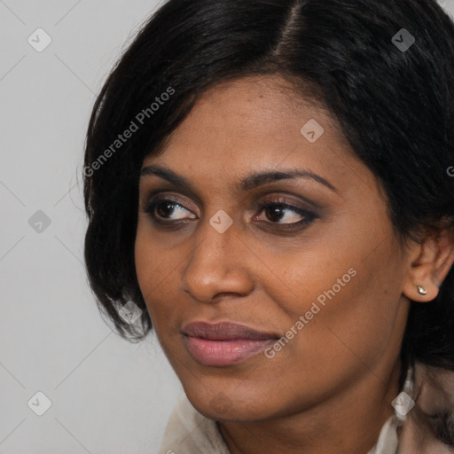 Joyful black young-adult female with medium  brown hair and brown eyes