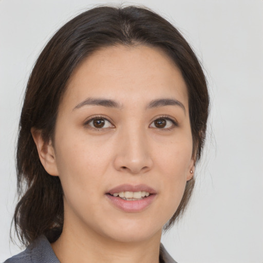 Joyful asian young-adult female with medium  brown hair and brown eyes