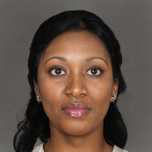 Joyful black young-adult female with long  black hair and brown eyes